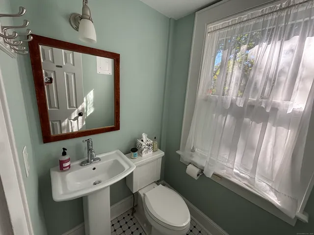 a bathroom with a sink toilet and mirror