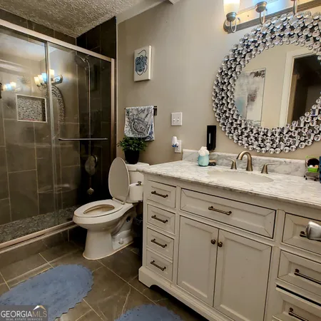 a bathroom with a toilet sink and shower