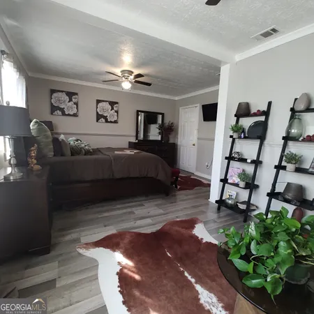 a bedroom with furniture and a wooden floor