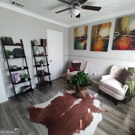 a living room with furniture and wooden floor