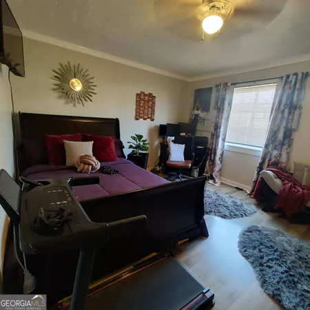 a bed room with furniture and wooden floor