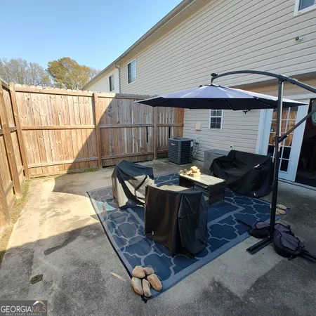 a backyard of a house with table and chairs