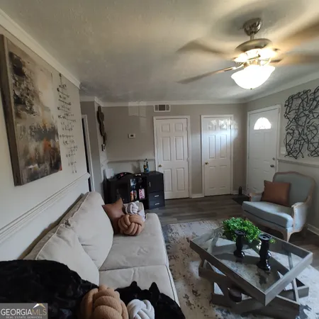 a living room with furniture and a chandelier