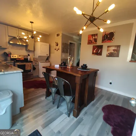 a view of a dining room with furniture and wooden floor