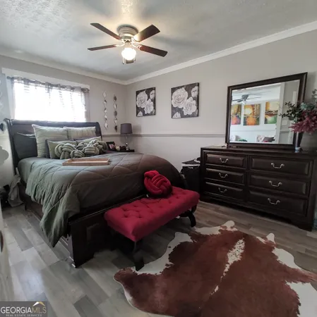 a bedroom with a bed and a dresser in it