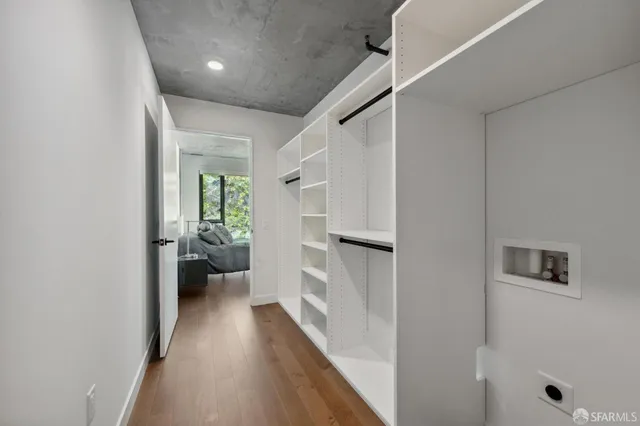 a view of a hallway to closet and wooden floor
