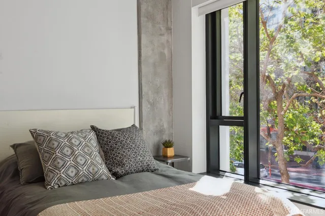 a bedroom with a bed and a window