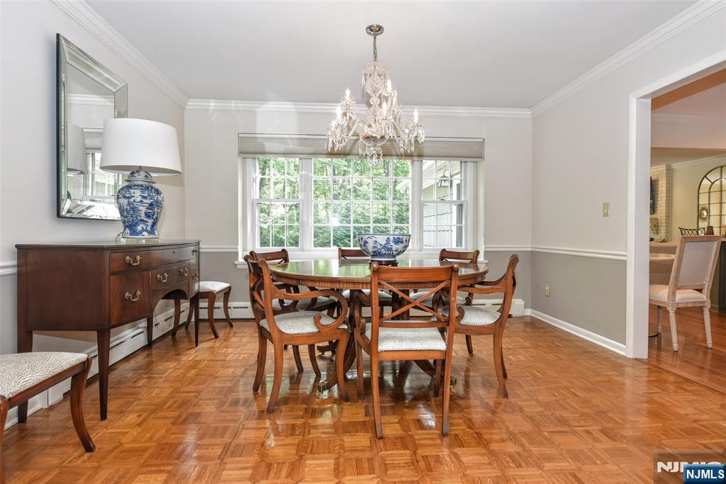 60 Dimmig Road Upper Saddle River, NJ 07458 - Photo 14 of 40 a dining room with furniture a chandelier and wooden floor