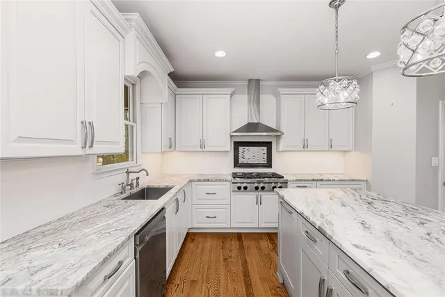 a kitchen with a sink stove and cabinets
