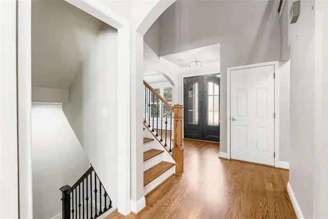 a view of a hallway with wooden floor and stairs
