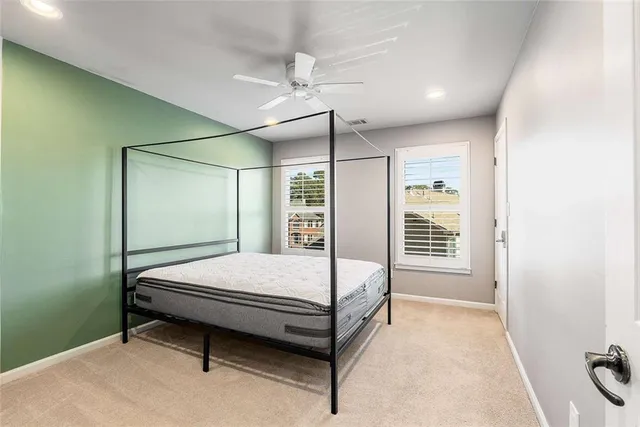 a bathroom with a granite countertop sink a toilet a shower and a mirror