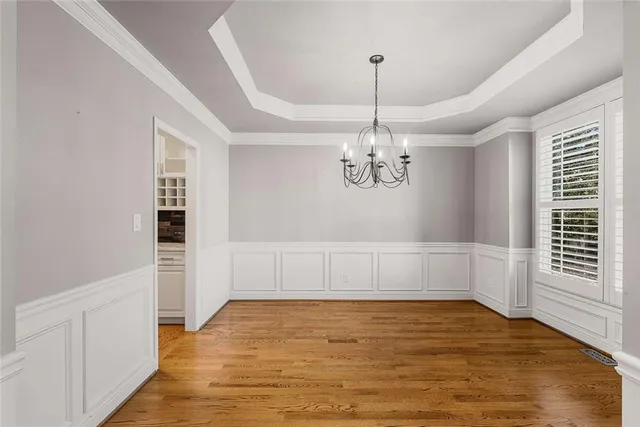 a view of a room with wooden floor and window
