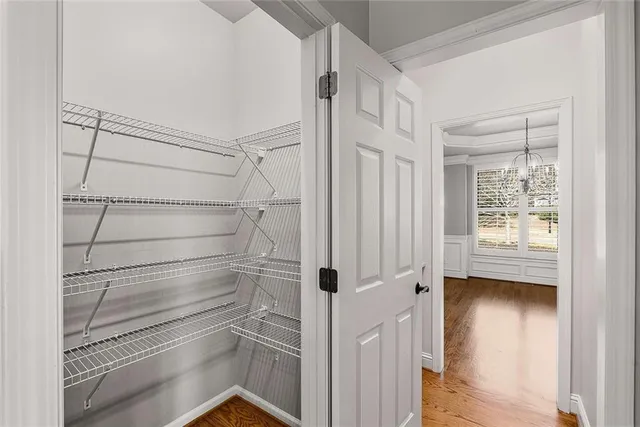 a view of walk in closet with empty racks