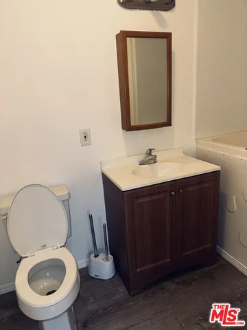 a white toilet sitting next to a bathroom sink