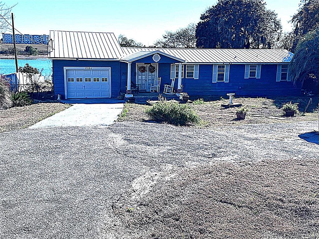 a front view of a house with yard and parking space