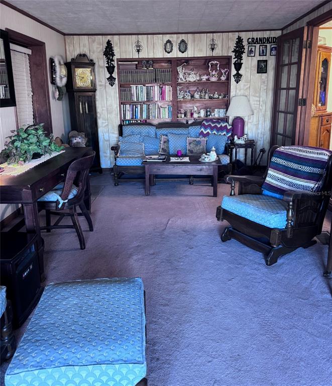 17134 Lake Ingram Road Winter Garden, FL 34787 - Photo 3 of 19 a living room with furniture and a book shelf