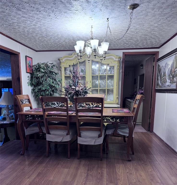 17134 Lake Ingram Road Winter Garden, FL 34787 - Photo 4 of 19 a view of a dining room with furniture and wooden floor