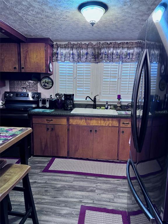 17134 Lake Ingram Road Winter Garden, FL 34787 - Photo 5 of 19 a kitchen with stainless steel appliances granite countertop a sink stove and cabinets