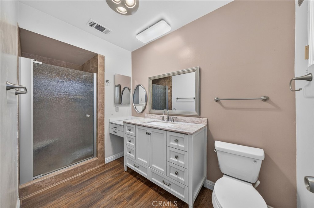 29078 Bradley Road Menifee, CA 92586 - Photo 28 of 42 a bathroom with a granite countertop toilet sink and mirror