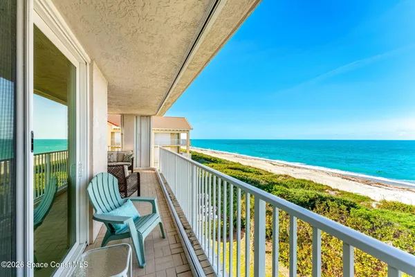 a view of a balcony with chairs