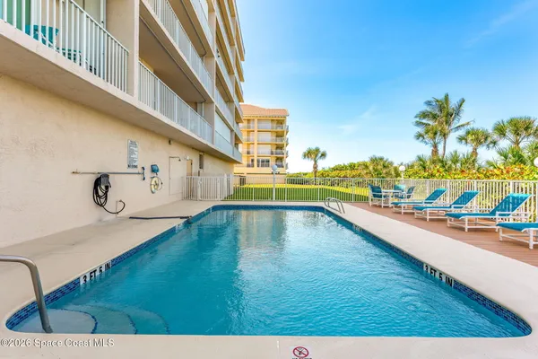 a view of a swimming pool and lounge chair