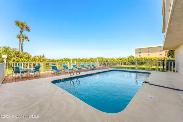 a view of a swimming pool and an outdoor seating