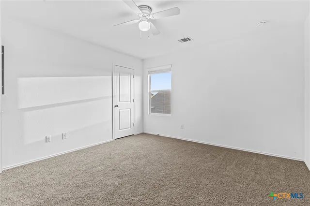 an empty room with a empty space and a ceiling fan