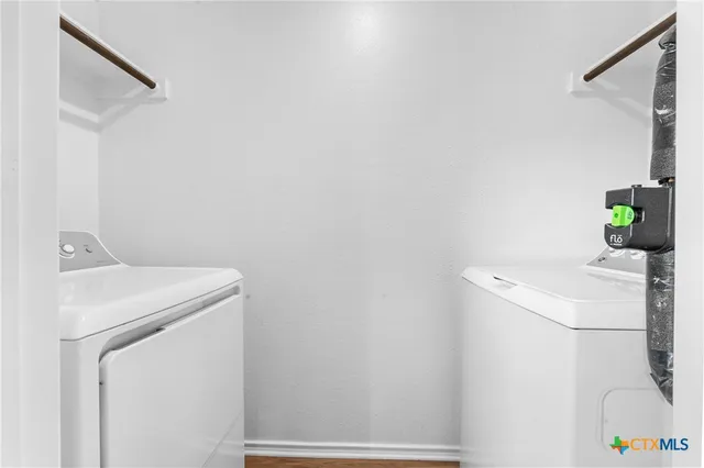 an empty room with a ceiling fan and wooden floor