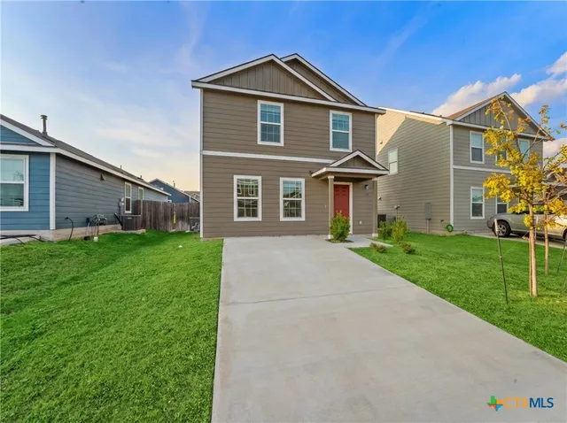 a front view of a house with a yard
