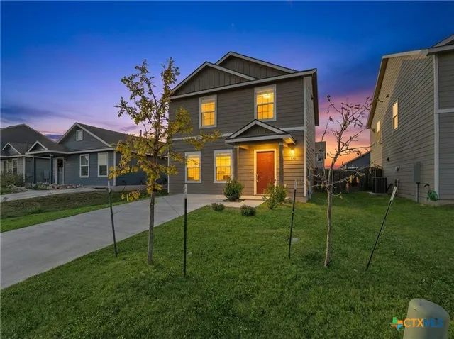 a front view of a house with a yard