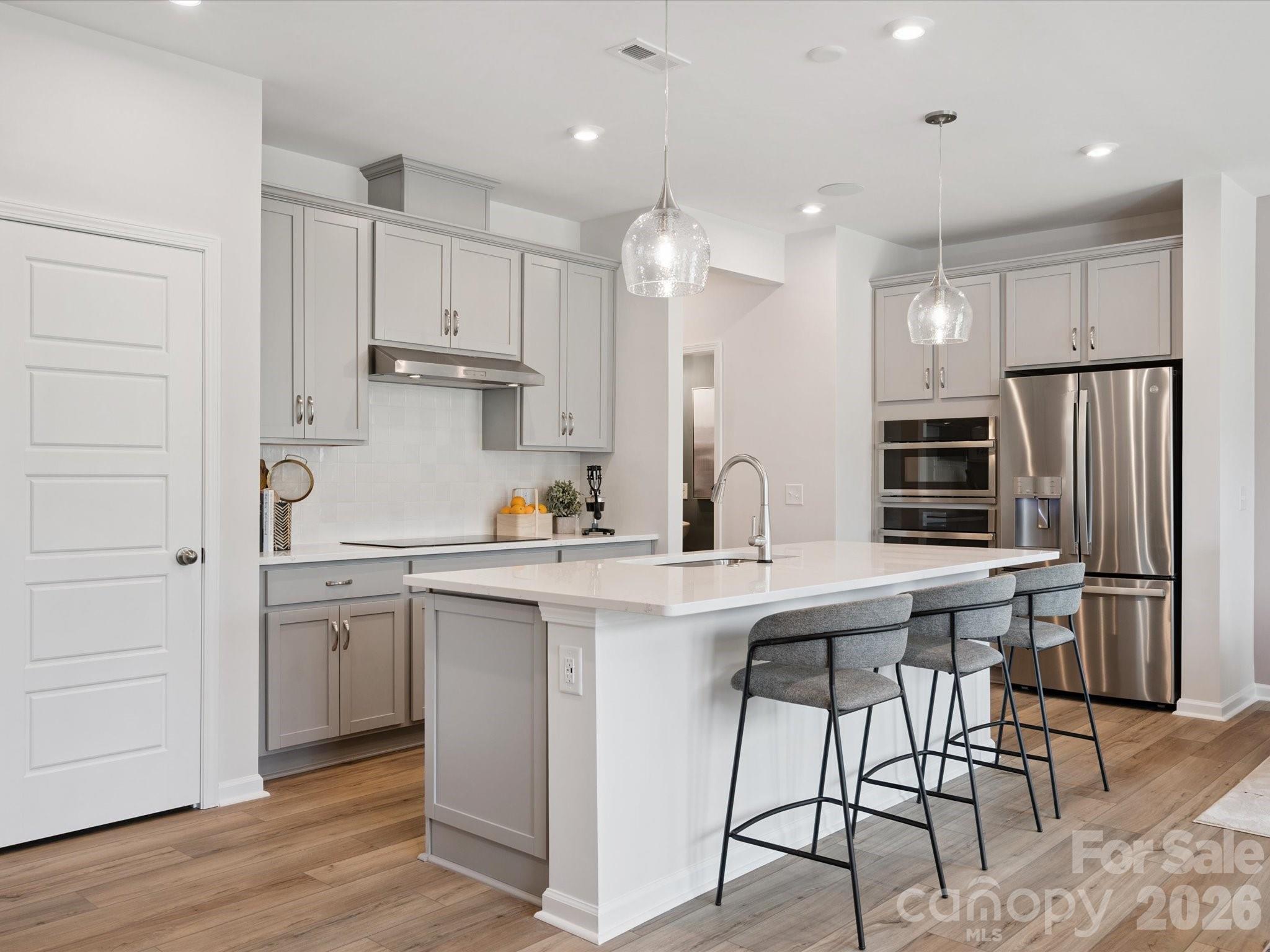 604 Webster Lane Cramerton, NC 28032 - Photo 1 of 20 a kitchen with stainless steel appliances granite countertop a sink a stove a refrigerator and island with wooden floor