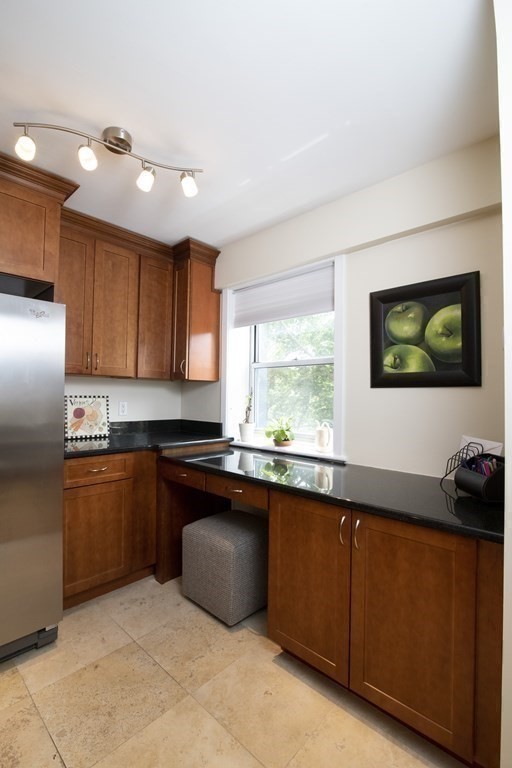 131 Sewall Avenue, Unit 37 Brookline, MA 02446 - Photo 11 of 27 a kitchen with stainless steel appliances granite countertop a sink dishwasher stove and refrigerator