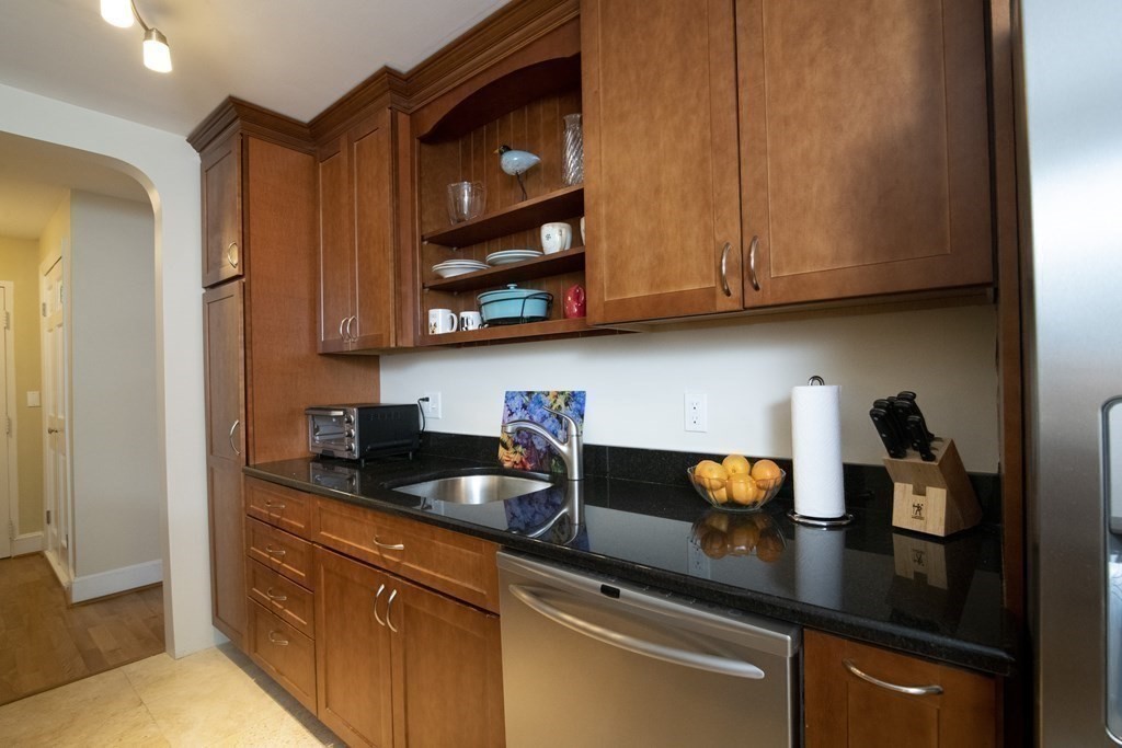 131 Sewall Avenue, Unit 37 Brookline, MA 02446 - Photo 13 of 27 a kitchen with stainless steel appliances granite countertop a sink a stove and cabinets