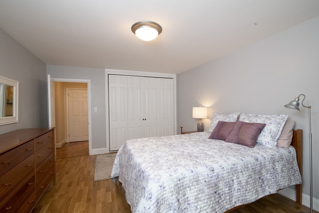 131 Sewall Avenue, Unit 37 Brookline, MA 02446 - Photo 21 of 27 a bedroom with a bed and a night stand