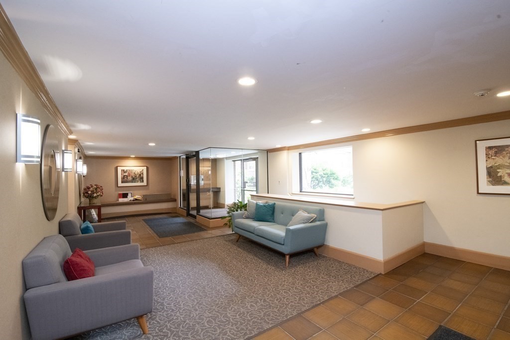 131 Sewall Avenue, Unit 37 Brookline, MA 02446 - Photo 23 of 27 a living room with furniture and a large window