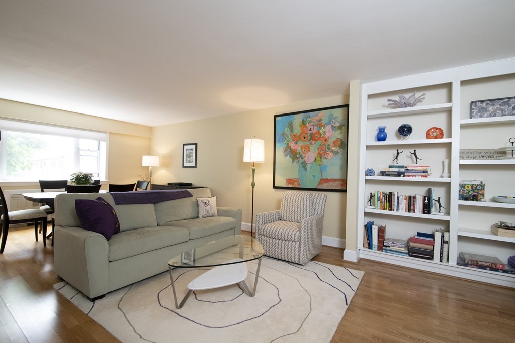 131 Sewall Avenue, Unit 37 Brookline, MA 02446 - Photo 3 of 27 a living room with furniture and a bookshelf