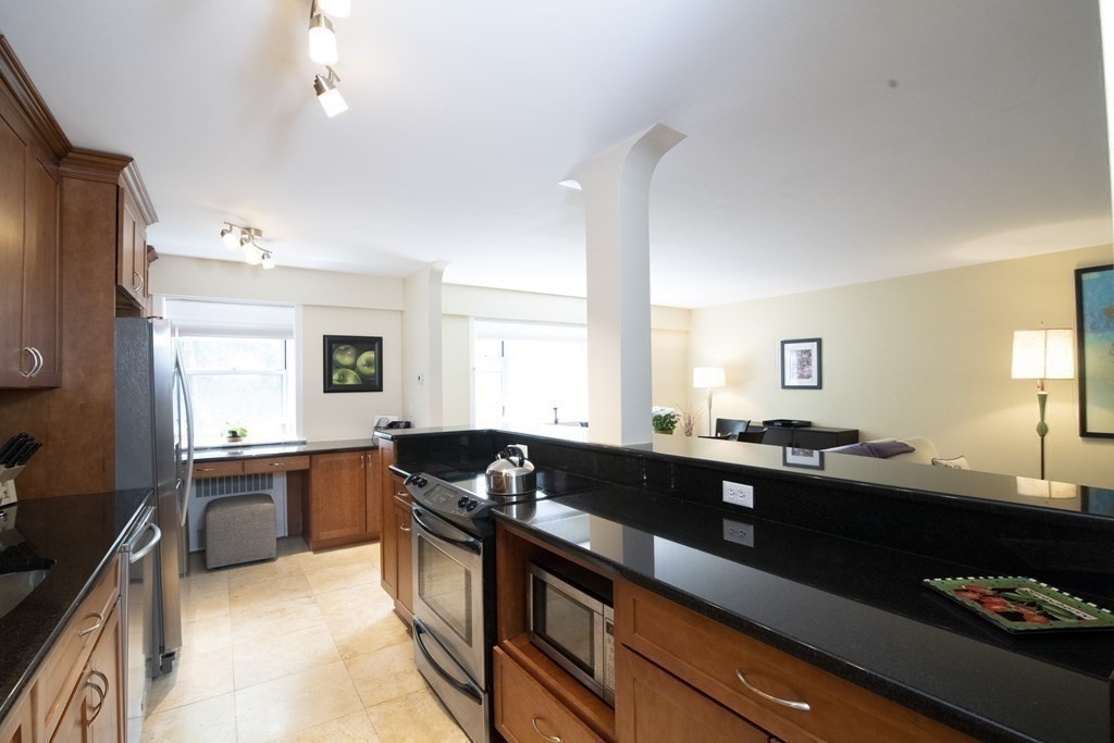 131 Sewall Avenue, Unit 37 Brookline, MA 02446 - Photo 10 of 27 a kitchen with a sink stove and refrigerator