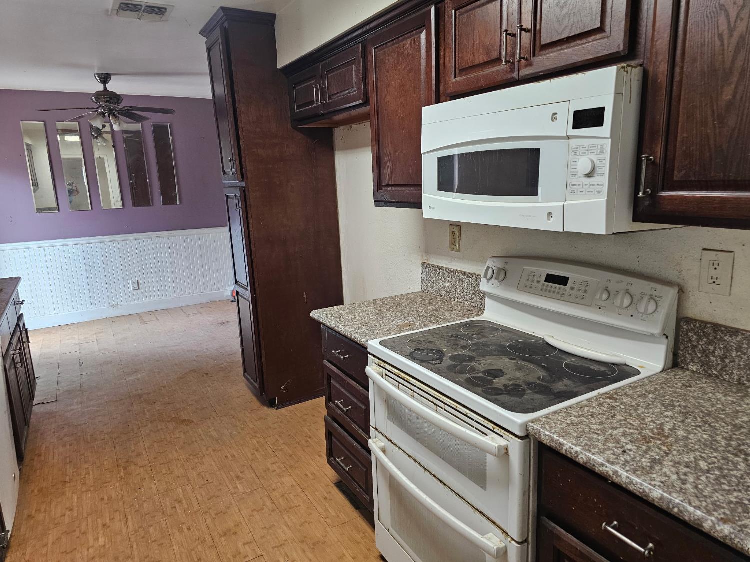 537 North Granada Drive Madera, CA 93637 - Photo 2 of 27 a kitchen with stainless steel appliances granite countertop a stove microwave and refrigerator