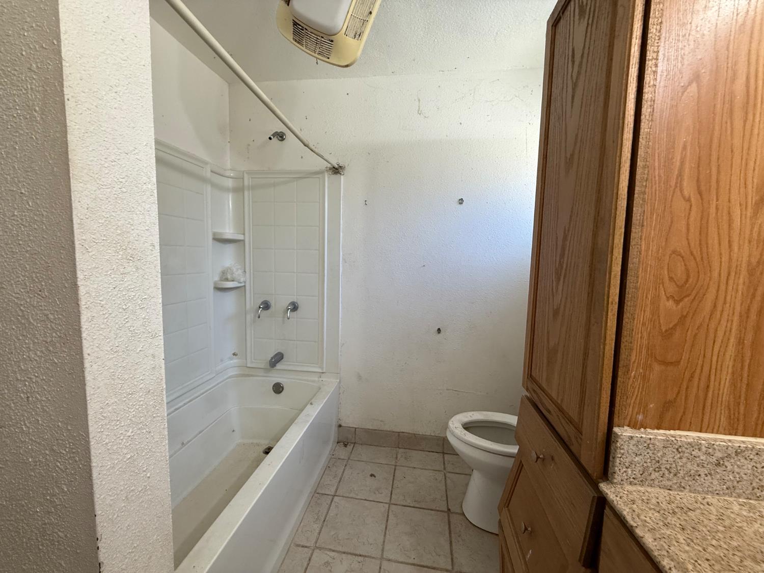 537 North Granada Drive Madera, CA 93637 - Photo 25 of 27 a bathroom with a granite countertop sink a toilet and shower