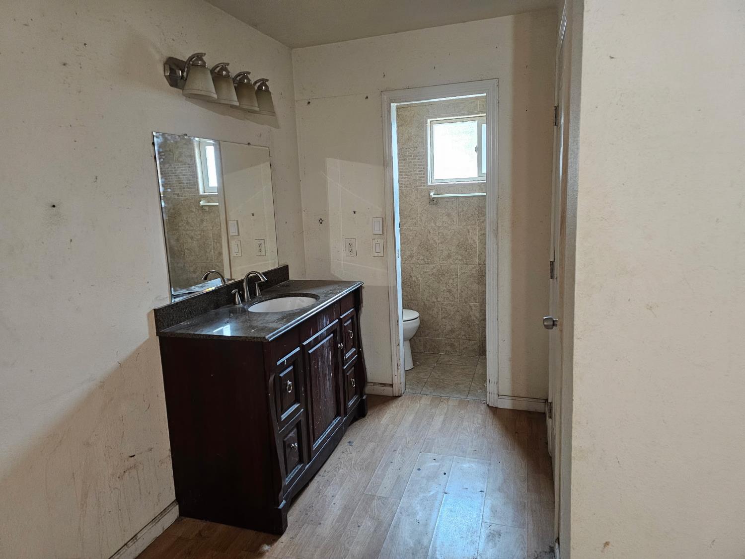 537 North Granada Drive Madera, CA 93637 - Photo 7 of 27 a view of a bathroom with a sink and a mirror