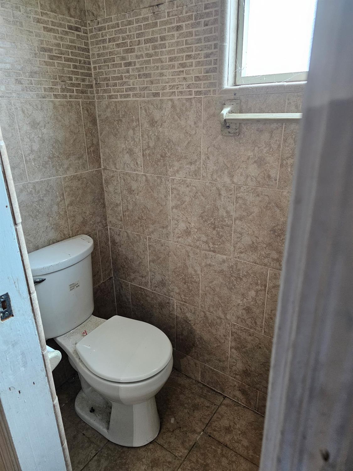 537 North Granada Drive Madera, CA 93637 - Photo 9 of 27 a white toilet sitting next to a window