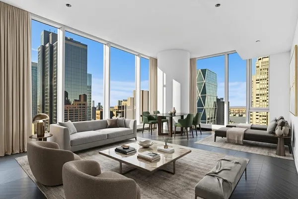 a living room with furniture and floor to ceiling windows