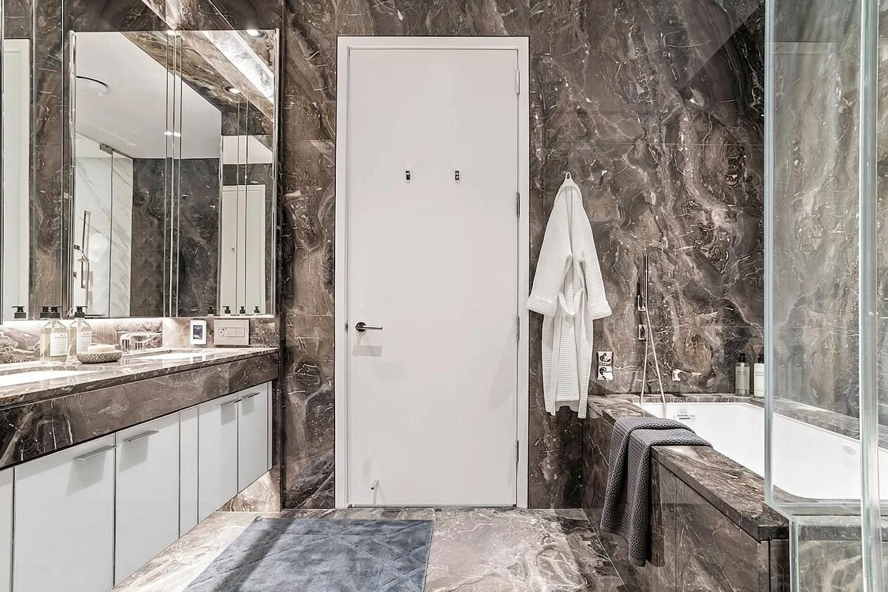 217 West 57th Street, Unit 43D Manhattan, NY 10019 - Photo 6 of 24 a bathroom with a sink and a mirror
