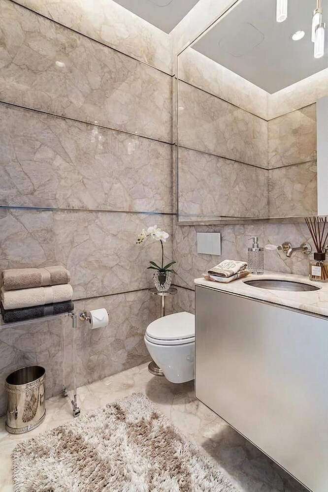 217 West 57th Street, Unit 43D Manhattan, NY 10019 - Photo 7 of 24 a bathroom with a toilet sink and mirror