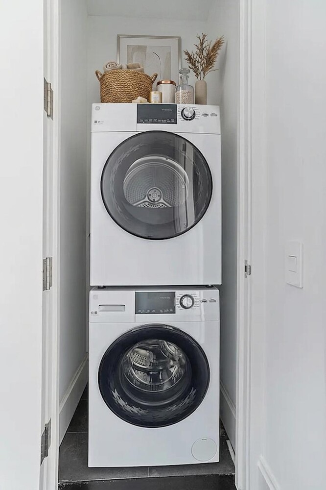 217 West 57th Street, Unit 43D Manhattan, NY 10019 - Photo 9 of 24 a utility room with a washer and dryer