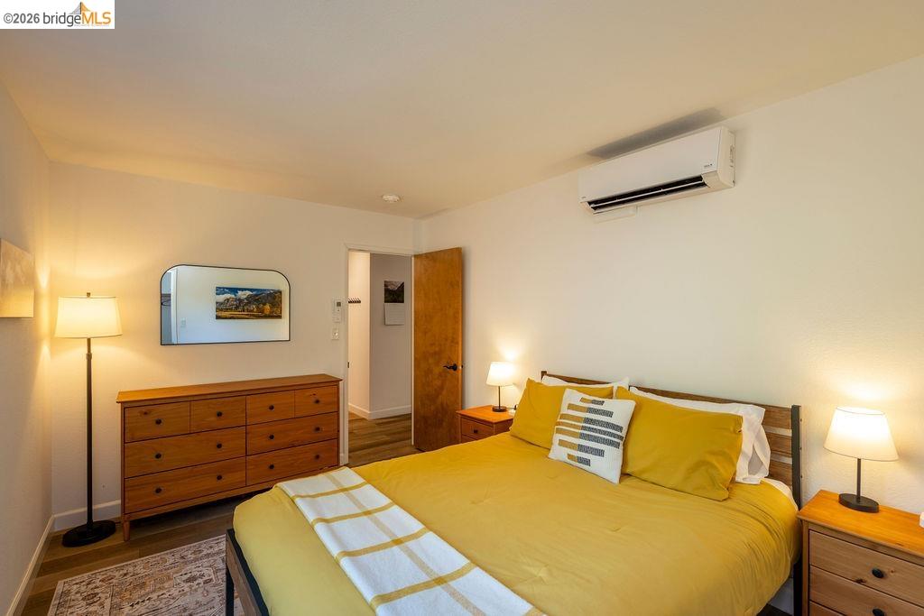 19266 Ferretti Road Groveland, CA 95321 - Photo 11 of 50 Bedroom with a wall mounted mini split and dark wood-style flooring