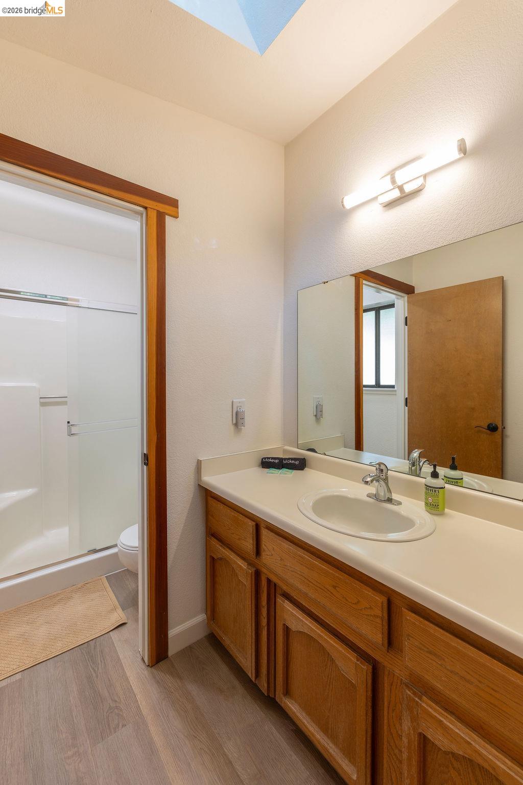 19266 Ferretti Road Groveland, CA 95321 - Photo 14 of 50 Full bath with vanity, a stall shower, and light wood finished floors