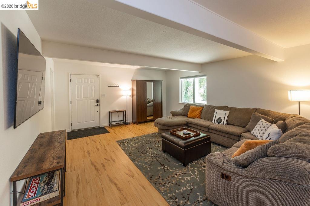 19266 Ferretti Road Groveland, CA 95321 - Photo 16 of 50 Living room with light wood finished floors and beamed ceiling