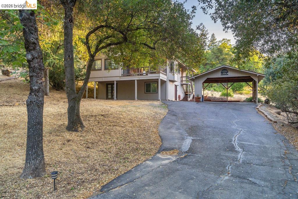 19266 Ferretti Road Groveland, CA 95321 - Photo 22 of 50 View of front of home featuring asphalt driveway, a deck, and a detached carport