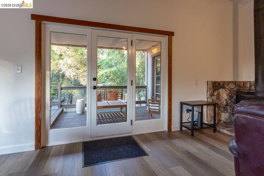 19266 Ferretti Road Groveland, CA 95321 - Photo 27 of 50 Entryway featuring wood finished floors and a wood stove